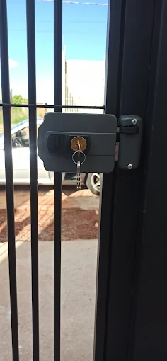 Fechadura elétrica instalada em um portão de grade preta